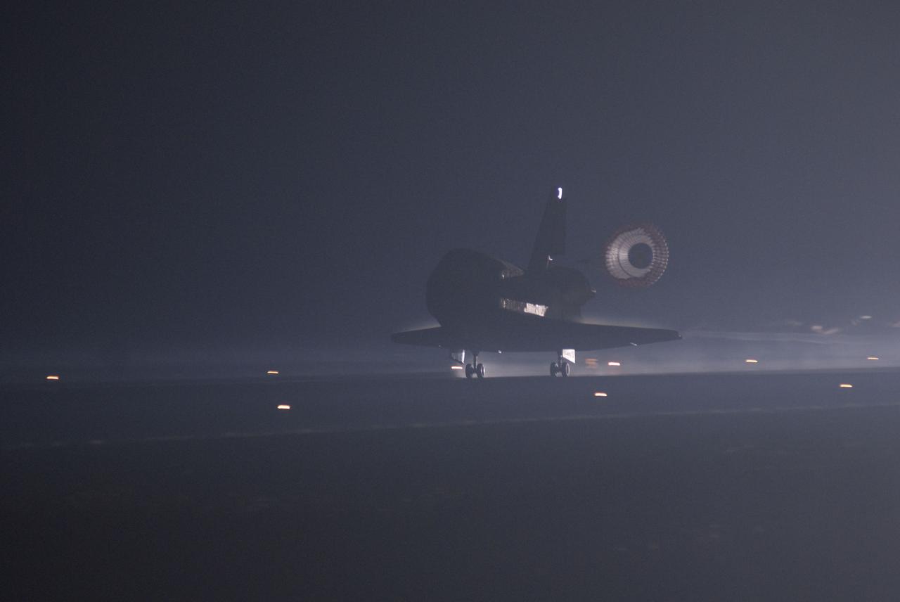 STS135-S-165 (21 July 2011) --- Xenon lights illuminate space shuttle Atlantis' unfurled drag chute as the vehicle rolls to a stop on the Shuttle Landing Facility's Runway 15 at NASA's Kennedy Space Center in Florida for the final time. Securing the space shuttle fleet's place in history, Atlantis marked the 26th nighttime landing of NASA's Space Shuttle Program and the 78th landing at Kennedy. Main gear touchdown was at 5:57:00 a.m. (EDT) on July 21, 2011, followed by nose gear touchdown at 5:57:20 a.m., and wheelstop at 5:57:54 a.m. Onboard are NASA astronauts Chris Ferguson, STS-135 commander; Doug Hurley, pilot; Sandy Magnus and Rex Walheim, both mission specialists. On the 37th shuttle mission to the International Space Station, STS-135 delivered more than 9,400 pounds of spare parts, equipment and supplies in the Raffaello multi-purpose logistics module that will sustain station operations for the next year. STS-135 was the 33rd and final flight for Atlantis, which has spent 307 days in space, orbited Earth 4,848 times and traveled 125,935,769 miles. Photo credit: NASA
