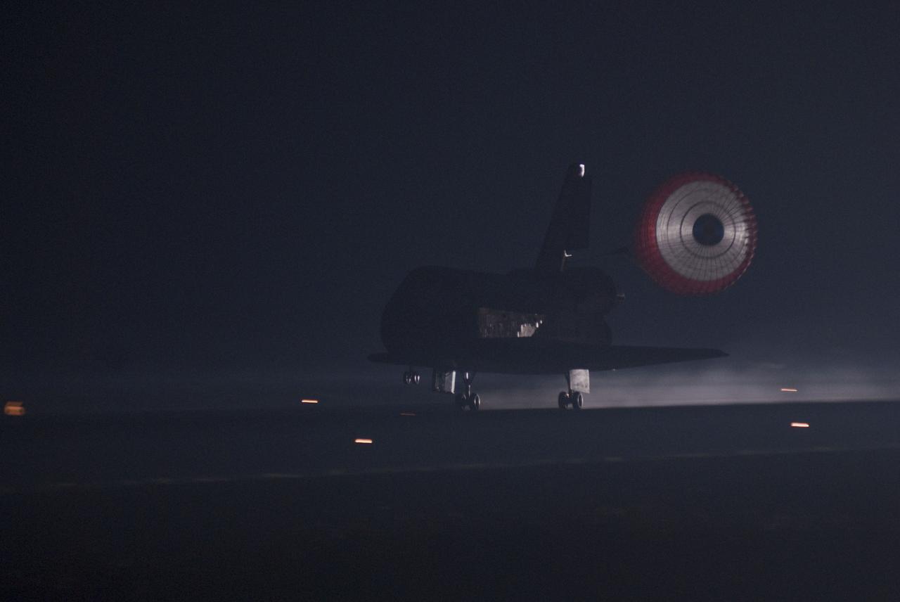STS135-S-166 (21 July 2011) --- Xenon lights illuminate space shuttle Atlantis' unfurled drag chute as the vehicle rolls to a stop on the Shuttle Landing Facility's Runway 15 at NASA's Kennedy Space Center in Florida for the final time. Securing the space shuttle fleet's place in history, Atlantis marked the 26th nighttime landing of NASA's Space Shuttle Program and the 78th landing at Kennedy. Main gear touchdown was at 5:57:00 a.m. (EDT) on July 21, 2011, followed by nose gear touchdown at 5:57:20 a.m., and wheelstop at 5:57:54 a.m. Onboard are NASA astronauts Chris Ferguson, STS-135 commander; Doug Hurley, pilot; Sandy Magnus and Rex Walheim, both mission specialists. On the 37th shuttle mission to the International Space Station, STS-135 delivered more than 9,400 pounds of spare parts, equipment and supplies in the Raffaello multi-purpose logistics module that will sustain station operations for the next year. STS-135 was the 33rd and final flight for Atlantis, which has spent 307 days in space, orbited Earth 4,848 times and traveled 125,935,769 miles. Photo credit: NASA