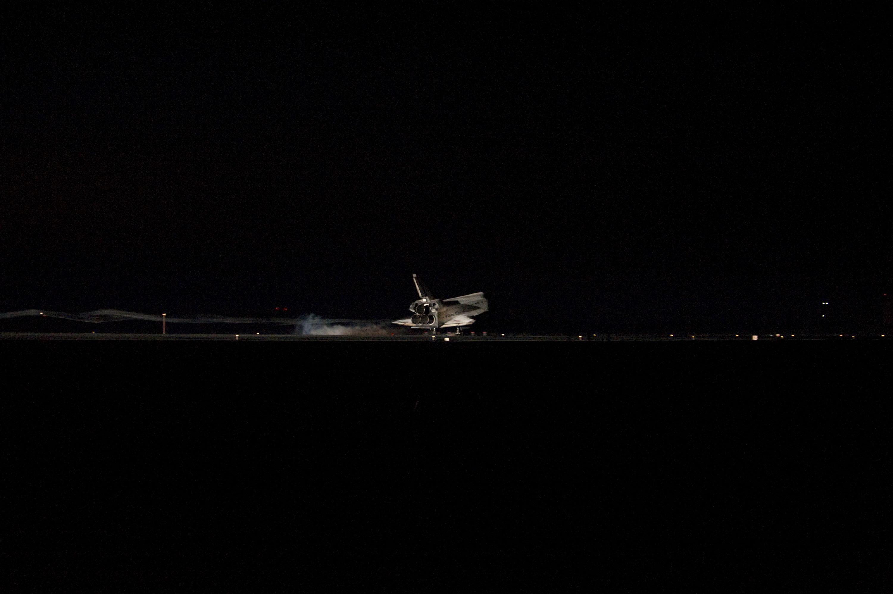 STS135-S-180 (21 July 2011) --- Space shuttle Atlantis' bright-white, iconic frame illuminates the darkness as it touches down on the Shuttle Landing Facility's Runway 15 at NASA's Kennedy Space Center in Florida for the final time. Securing the space shuttle fleet's place in history, Atlantis marked the 26th nighttime landing of NASA's Space Shuttle Program and the 78th landing at Kennedy. Main gear touchdown was at 5:57:00 a.m. (EDT) on July 21, 2011, followed by nose gear touchdown at 5:57:20 a.m., and wheelstop at 5:57:54 a.m. Onboard are NASA astronauts Chris Ferguson, STS-135 commander; Doug Hurley, pilot; Sandy Magnus and Rex Walheim, both mission specialists. On the 37th shuttle mission to the International Space Station, STS-135 delivered more than 9,400 pounds of spare parts, equipment and supplies in the Raffaello multi-purpose logistics module that will sustain station operations for the next year. STS-135 was the 33rd and final flight for Atlantis, which has spent 307 days in space, orbited Earth 4,848 times and traveled 125,935,769 miles. Photo credit: NASA