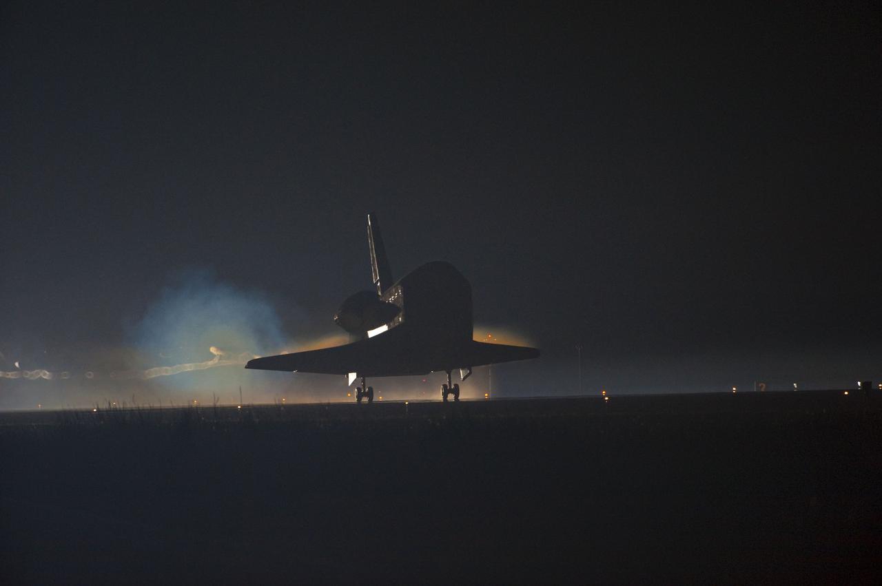 STS135-S-188 (21 July 2011) --- Ribbons of steam and smoke trail space shuttle Atlantis as it touches down on the Shuttle Landing Facility's Runway 15 at NASA's Kennedy Space Center in Florida for the final time. Securing the space shuttle fleet's place in history, Atlantis marked the 26th nighttime landing of NASA's Space Shuttle Program and the 78th landing at Kennedy. Main gear touchdown was at 5:57:00 a.m. (EDT) on July 21, 2011, followed by nose gear touchdown at 5:57:20 a.m., and wheelstop at 5:57:54 a.m. Onboard are NASA astronauts Chris Ferguson, STS-135 commander; Doug Hurley, pilot; Sandy Magnus and Rex Walheim, both mission specialists. On the 37th shuttle mission to the International Space Station, STS-135 delivered more than 9,400 pounds of spare parts, equipment and supplies in the Raffaello multi-purpose logistics module that will sustain station operations for the next year. STS-135 was the 33rd and final flight for Atlantis, which has spent 307 days in space, orbited Earth 4,848 times and traveled 125,935,769 miles. Photo credit: NASA