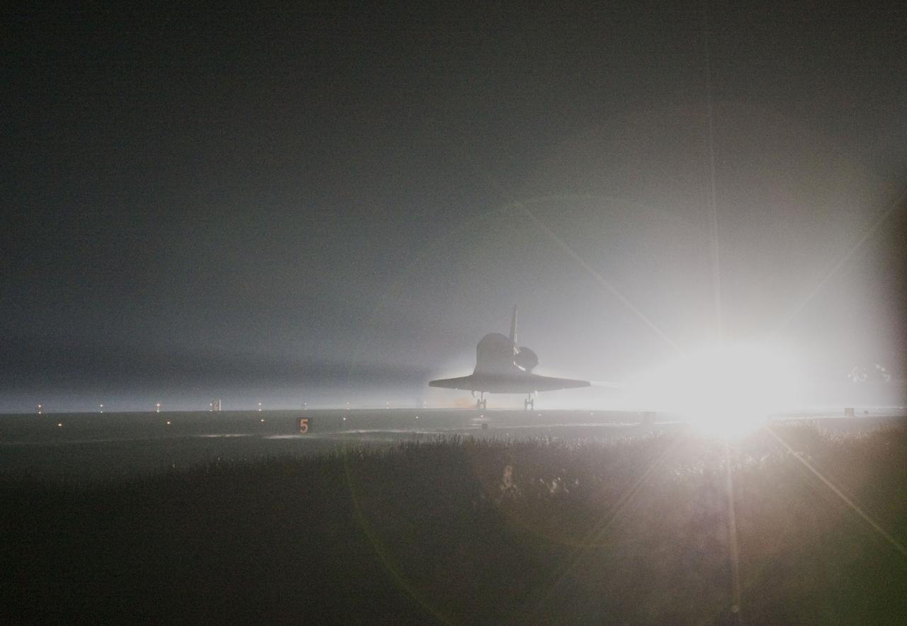 STS135-S-217 (21 July 2011) --- Space shuttle Atlantis returns to Earth for the last time on Runway 15 at NASA's Kennedy Space Center in Florida just before sunrise July 21, 2011. Atlantis touched down on Runway 15 at 5:57 a.m. (EDT), bringing an end to the STS-135 mission and NASA's Space Shuttle Program. Onboard are NASA astronauts Chris Ferguson, commander; Doug Hurley, pilot; Sandy Magnus and Rex Walheim, both mission specialists. On the 37th shuttle mission to the International Space Station, STS-135 delivered more than 9,400 pounds of spare parts, equipment and supplies in the Raffaello multi-purpose logistics module that will sustain station operations for the next year. STS-135 was the 33rd and final flight for Atlantis, which has spent 307 days in space, orbited Earth 4,848 times and traveled 125,935,769 miles. Photo credit: NASA