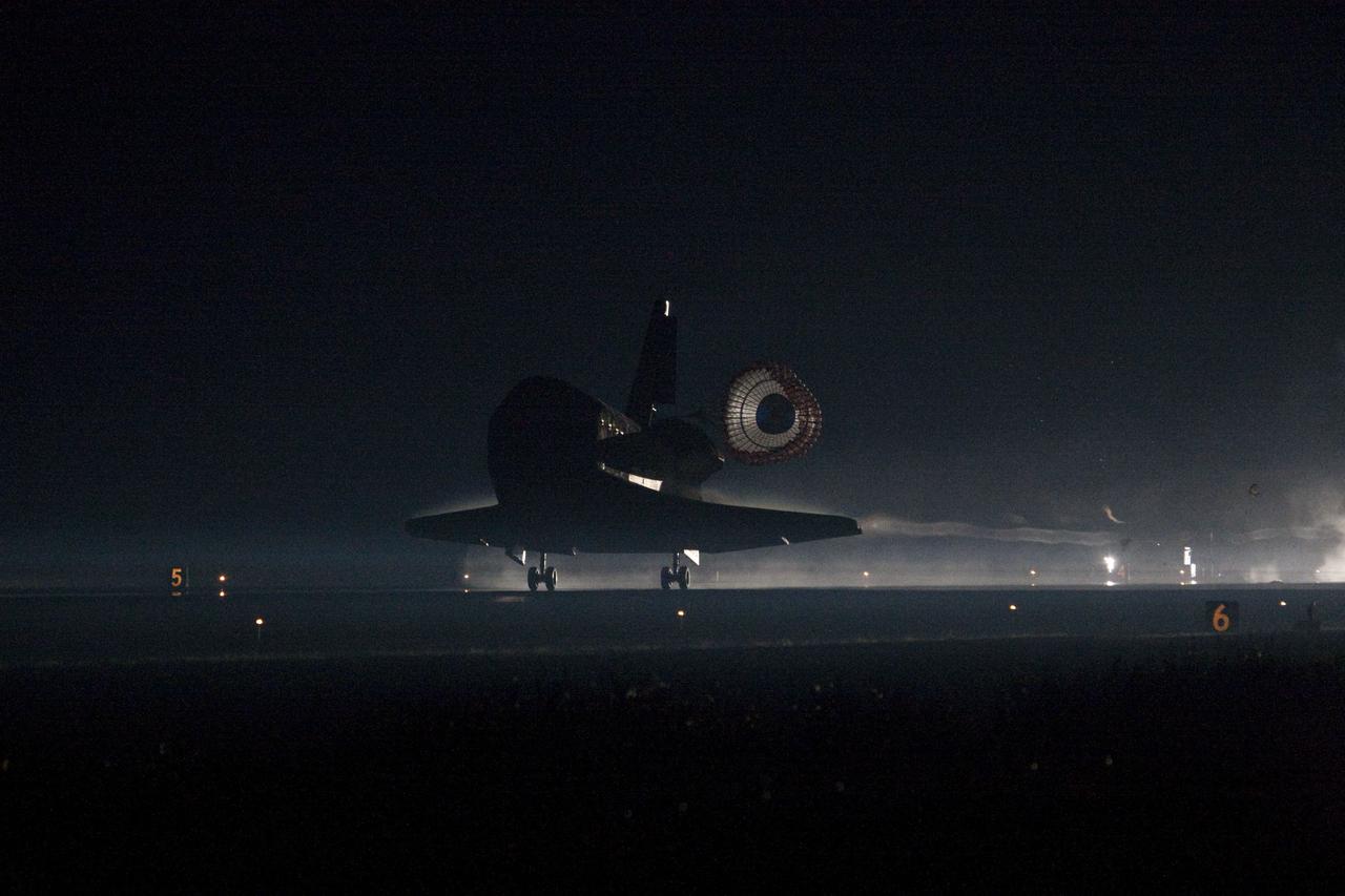 STS135-S-219 (21 July 2011) --- Space shuttle Atlantis returns to Earth for the last time on Runway 15 at NASA's Kennedy Space Center in Florida just before sunrise July 21, 2011. Atlantis touched down on Runway 15 at 5:57 a.m. (EDT), bringing an end to the STS-135 mission and NASA's Space Shuttle Program. Onboard are NASA astronauts Chris Ferguson, commander; Doug Hurley, pilot; Sandy Magnus and Rex Walheim, both mission specialists. On the 37th shuttle mission to the International Space Station, STS-135 delivered more than 9,400 pounds of spare parts, equipment and supplies in the Raffaello multi-purpose logistics module that will sustain station operations for the next year. STS-135 was the 33rd and final flight for Atlantis, which has spent 307 days in space, orbited Earth 4,848 times and traveled 125,935,769 miles. Photo credit: NASA