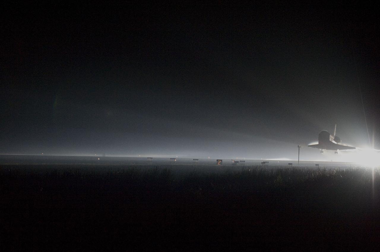 STS135-S-220 (21 July 2011) --- Space shuttle Atlantis returns to Earth for the last time on Runway 15 at NASA's Kennedy Space Center in Florida just before sunrise July 21, 2011. Atlantis touched down on Runway 15 at 5:57 a.m. (EDT), bringing an end to the STS-135 mission and NASA's Space Shuttle Program. Onboard are NASA astronauts Chris Ferguson, commander; Doug Hurley, pilot; Sandy Magnus and Rex Walheim, both mission specialists. On the 37th shuttle mission to the International Space Station, STS-135 delivered more than 9,400 pounds of spare parts, equipment and supplies in the Raffaello multi-purpose logistics module that will sustain station operations for the next year. STS-135 was the 33rd and final flight for Atlantis, which has spent 307 days in space, orbited Earth 4,848 times and traveled 125,935,769 miles. Photo credit: NASA