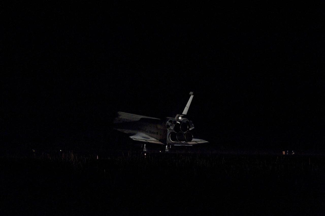 STS135-S-223 (21 July 2011) --- Space shuttle Atlantis' bright-white, iconic frame appears from the darkness at it touches down on the Shuttle Landing Facility's Runway 15 at NASA's Kennedy Space Center in Florida for the final time. Securing the space shuttle fleet's place in history, Atlantis marked the 26th nighttime landing of NASA's Space Shuttle Program and the 78th landing at Kennedy. Main gear touchdown was at 5:57:00 a.m. (EDT) on July 21, 2011, followed by nose gear touchdown at 5:57:20 a.m., and wheelstop at 5:57:54 a.m. Onboard are NASA astronauts Chris Ferguson, STS-135 commander; Doug Hurley, pilot; Sandy Magnus and Rex Walheim, both mission specialists. On the 37th shuttle mission to the International Space Station, STS-135 delivered more than 9,400 pounds of spare parts, equipment and supplies in the Raffaello multi-purpose logistics module that will sustain station operations for the next year. STS-135 was the 33rd and final flight for Atlantis, which has spent 307 days in space, orbited Earth 4,848 times and traveled 125,935,769 miles. Photo credit: NASA