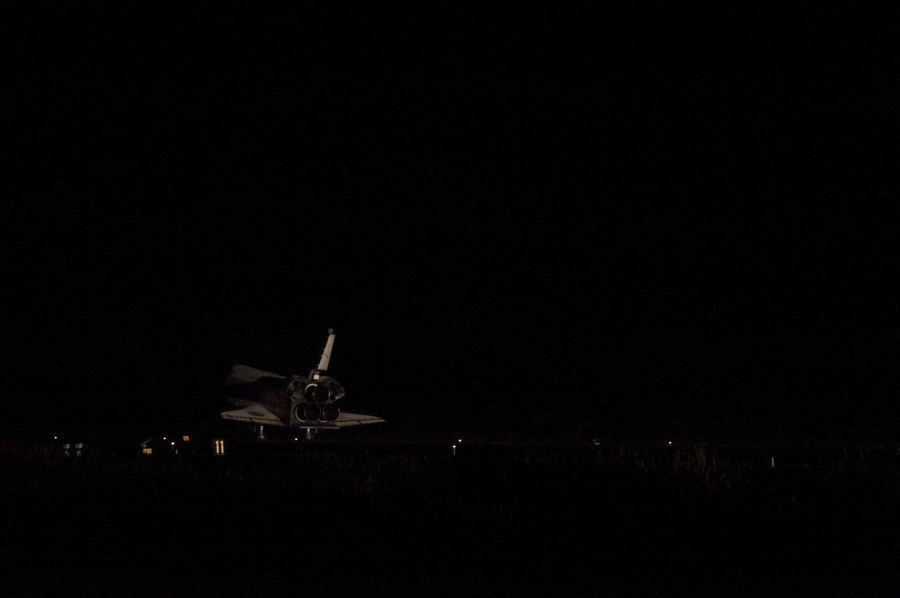 STS135-S-224 (21 July 2011) --- Space shuttle Atlantis' bright-white, iconic frame appears from the darkness at it touches down on the Shuttle Landing Facility's Runway 15 at NASA's Kennedy Space Center in Florida for the final time. Securing the space shuttle fleet's place in history, Atlantis marked the 26th nighttime landing of NASA's Space Shuttle Program and the 78th landing at Kennedy. Main gear touchdown was at 5:57:00 a.m. (EDT) on July 21, 2011, followed by nose gear touchdown at 5:57:20 a.m., and wheelstop at 5:57:54 a.m. Onboard are NASA astronauts Chris Ferguson, STS-135 commander; Doug Hurley, pilot; Sandy Magnus and Rex Walheim, both mission specialists. On the 37th shuttle mission to the International Space Station, STS-135 delivered more than 9,400 pounds of spare parts, equipment and supplies in the Raffaello multi-purpose logistics module that will sustain station operations for the next year. STS-135 was the 33rd and final flight for Atlantis, which has spent 307 days in space, orbited Earth 4,848 times and traveled 125,935,769 miles. Photo credit: NASA