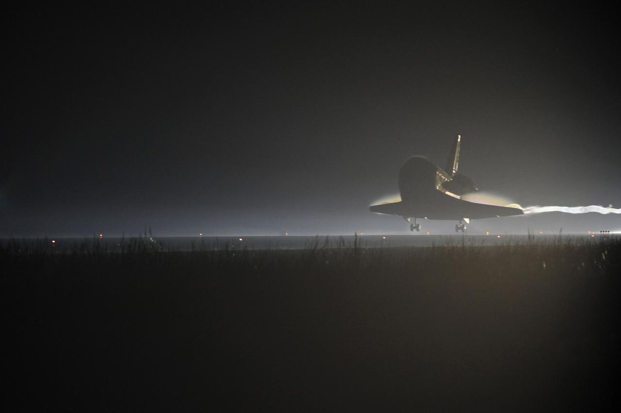 STS135-S-230 (21 July 2011) --- Ribbons of steam and smoke trail space shuttle Atlantis as it nears touchdown on the Shuttle Landing Facility's Runway 15 at NASA's Kennedy Space Center in Florida for the final time. Securing the space shuttle fleet's place in history, Atlantis marked the 26th nighttime landing of NASA's Space Shuttle Program and the 78th landing at Kennedy. Main gear touchdown was at 5:57:00 a.m. (EDT) on July 21, 2011, followed by nose gear touchdown at 5:57:20 a.m., and wheelstop at 5:57:54 a.m. Onboard are NASA astronauts Chris Ferguson, STS-135 commander; Doug Hurley, pilot; Sandy Magnus and Rex Walheim, both mission specialists. On the 37th shuttle mission to the International Space Station, STS-135 delivered more than 9,400 pounds of spare parts, equipment and supplies in the Raffaello multi-purpose logistics module that will sustain station operations for the next year. STS-135 was the 33rd and final flight for Atlantis, which has spent 307 days in space, orbited Earth 4,848 times and traveled 125,935,769 miles. Photo credit: NASA