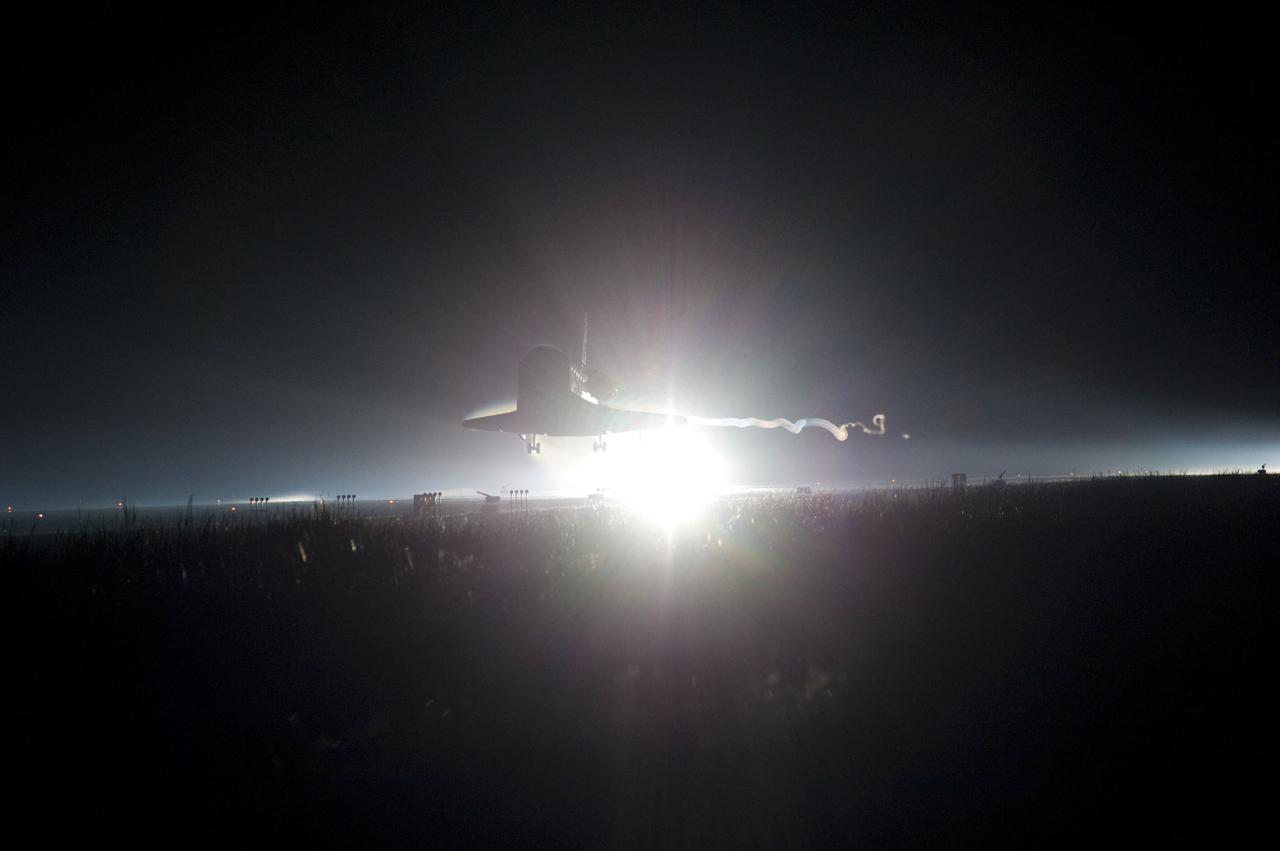 STS135-S-234 (21 July 2011) --- Ribbons of steam and smoke trail space shuttle Atlantis as it nears touchdown on the Shuttle Landing Facility's Runway 15 at NASA's Kennedy Space Center in Florida for the final time. Securing the space shuttle fleet's place in history, Atlantis marked the 26th nighttime landing of NASA's Space Shuttle Program and the 78th landing at Kennedy. Main gear touchdown was at 5:57:00 a.m. (EDT) on July 21, 2011, followed by nose gear touchdown at 5:57:20 a.m., and wheelstop at 5:57:54 a.m. Onboard are NASA astronauts Chris Ferguson, STS-135 commander; Doug Hurley, pilot; Sandy Magnus and Rex Walheim, both mission specialists. On the 37th shuttle mission to the International Space Station, STS-135 delivered more than 9,400 pounds of spare parts, equipment and supplies in the Raffaello multi-purpose logistics module that will sustain station operations for the next year. STS-135 was the 33rd and final flight for Atlantis, which has spent 307 days in space, orbited Earth 4,848 times and traveled 125,935,769 miles. Photo credit: NASA