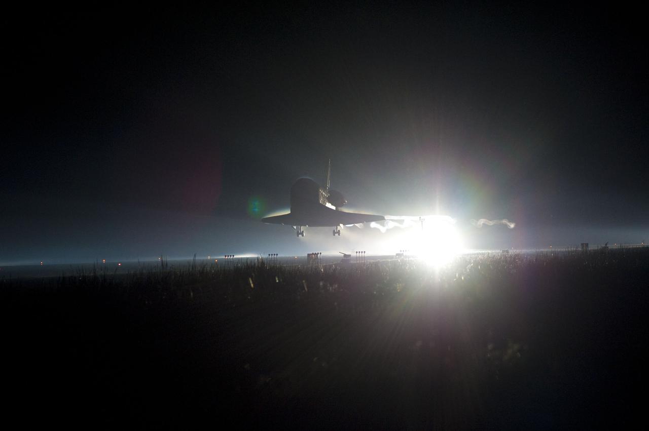 STS135-S-235 (21 July 2011) --- Ribbons of steam and smoke trail space shuttle Atlantis as it nears touchdown on the Shuttle Landing Facility's Runway 15 at NASA's Kennedy Space Center in Florida for the final time. Securing the space shuttle fleet's place in history, Atlantis marked the 26th nighttime landing of NASA's Space Shuttle Program and the 78th landing at Kennedy. Main gear touchdown was at 5:57:00 a.m. (EDT) on July 21, 2011, followed by nose gear touchdown at 5:57:20 a.m., and wheelstop at 5:57:54 a.m. Onboard are NASA astronauts Chris Ferguson, STS-135 commander; Doug Hurley, pilot; Sandy Magnus and Rex Walheim, both mission specialists. On the 37th shuttle mission to the International Space Station, STS-135 delivered more than 9,400 pounds of spare parts, equipment and supplies in the Raffaello multi-purpose logistics module that will sustain station operations for the next year. STS-135 was the 33rd and final flight for Atlantis, which has spent 307 days in space, orbited Earth 4,848 times and traveled 125,935,769 miles. Photo credit: NASA