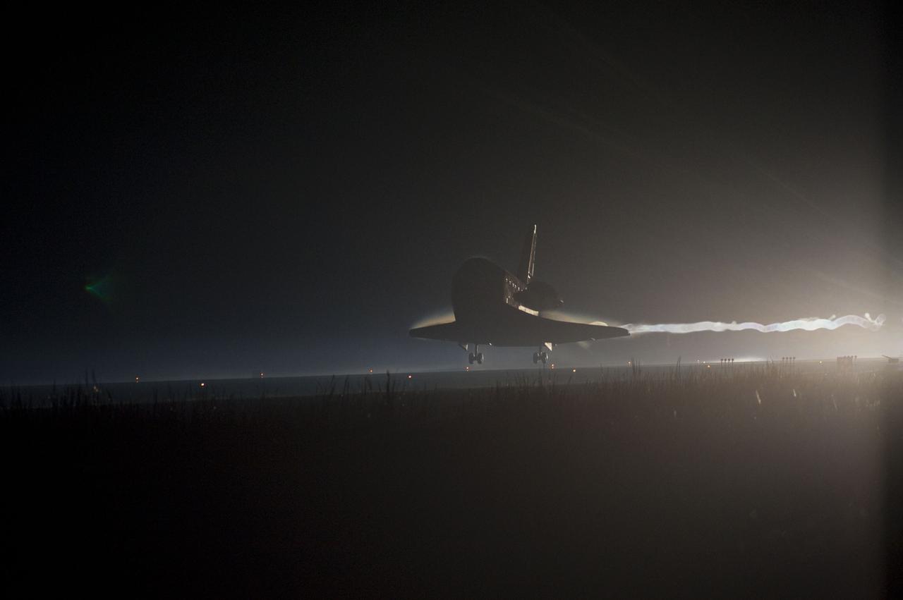 STS135-S-236 (21 July 2011) --- Ribbons of steam and smoke trail space shuttle Atlantis as it nears touchdown on the Shuttle Landing Facility's Runway 15 at NASA's Kennedy Space Center in Florida for the final time. Securing the space shuttle fleet's place in history, Atlantis marked the 26th nighttime landing of NASA's Space Shuttle Program and the 78th landing at Kennedy. Main gear touchdown was at 5:57:00 a.m. (EDT) on July 21, 2011, followed by nose gear touchdown at 5:57:20 a.m., and wheelstop at 5:57:54 a.m. Onboard are NASA astronauts Chris Ferguson, STS-135 commander; Doug Hurley, pilot; Sandy Magnus and Rex Walheim, both mission specialists. On the 37th shuttle mission to the International Space Station, STS-135 delivered more than 9,400 pounds of spare parts, equipment and supplies in the Raffaello multi-purpose logistics module that will sustain station operations for the next year. STS-135 was the 33rd and final flight for Atlantis, which has spent 307 days in space, orbited Earth 4,848 times and traveled 125,935,769 miles. Photo credit: NASA