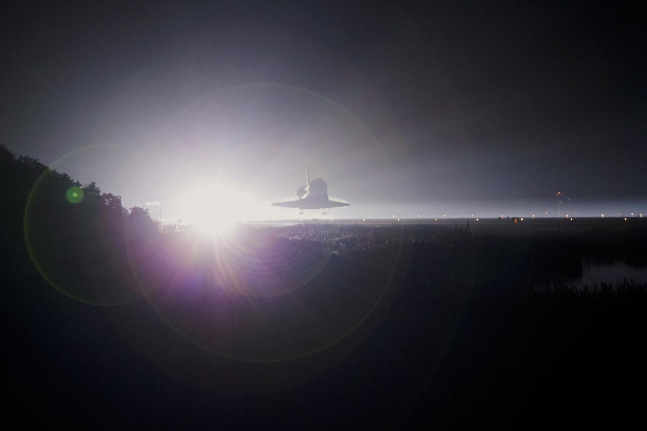 STS135-S-241 (21 July 2011) --- Xenon lights cast a halo of light on space shuttle Atlantis as the spacecraft nears touchdown for the last time on Runway 15 at NASA's Kennedy Space Center in Florida. Securing the space shuttle fleet's place in history, Atlantis marked the 26th nighttime landing of NASA's Space Shuttle Program and the 78th landing at Kennedy. Main gear touchdown was at 5:57:00 a.m. (EDT) on July 21, 2011, followed by nose gear touchdown at 5:57:20 a.m., and wheelstop at 5:57:54 a.m. Onboard are NASA astronauts Chris Ferguson, STS-135 commander; Doug Hurley, pilot; Sandy Magnus and Rex Walheim, both mission specialists. On the 37th shuttle mission to the International Space Station, STS-135 delivered more than 9,400 pounds of spare parts, equipment and supplies in the Raffaello multi-purpose logistics module that will sustain station operations for the next year. STS-135 was the 33rd and final flight for Atlantis, which has spent 307 days in space, orbited Earth 4,848 times and traveled 125,935,769 miles. Photo credit: NASA