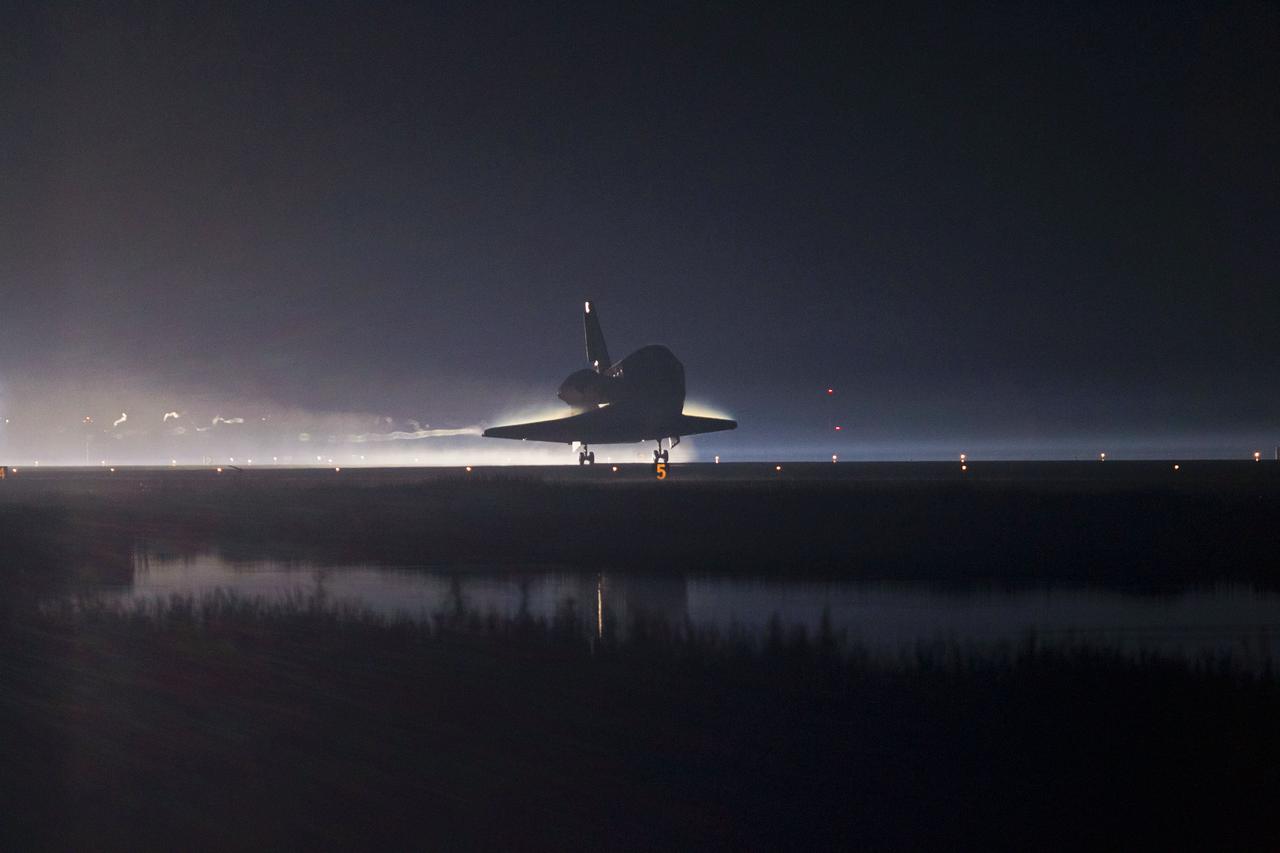 STS135-S-247 (21 July 2011) --- Xenon lights guide space shuttle Atlantis as it lands on the Shuttle Landing Facility's Runway 15 at NASA's Kennedy Space Center in Florida for the final time. Securing the space shuttle fleet's place in history, Atlantis marked the 26th nighttime landing of NASA's Space Shuttle Program and the 78th landing at Kennedy. Main gear touchdown was at 5:57:00 a.m. (EDT) on July 21, 2011, followed by nose gear touchdown at 5:57:20 a.m., and wheelstop at 5:57:54 a.m. Onboard are NASA astronauts Chris Ferguson, STS-135 commander; Doug Hurley, pilot; Sandy Magnus and Rex Walheim, both mission specialists. On the 37th shuttle mission to the International Space Station, STS-135 delivered more than 9,400 pounds of spare parts, equipment and supplies in the Raffaello multi-purpose logistics module that will sustain station operations for the next year. STS-135 was the 33rd and final flight for Atlantis, which has spent 307 days in space, orbited Earth 4,848 times and traveled 125,935,769 miles. Photo credit: NASA