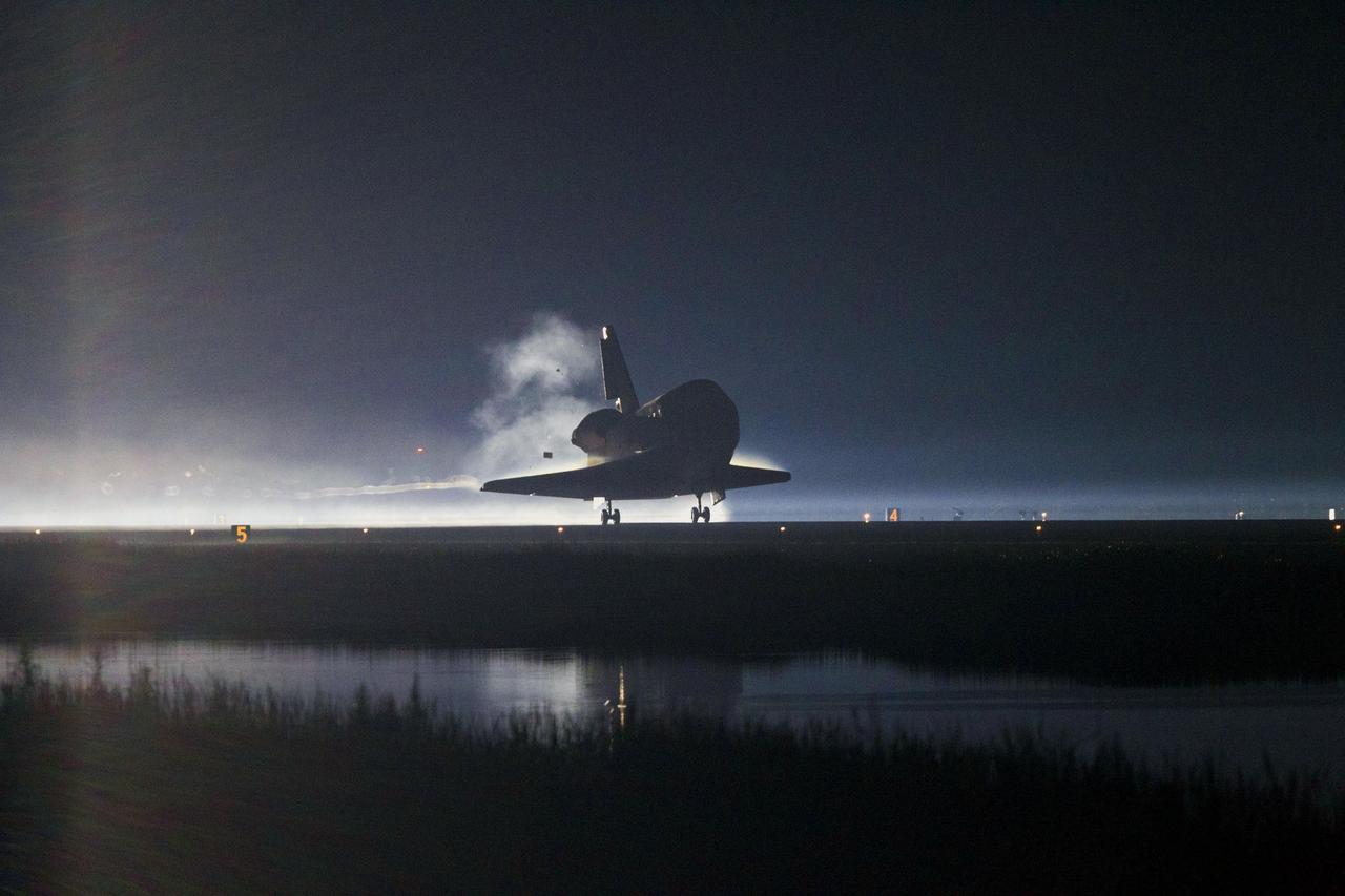 STS135-S-248 (21 July 2011) --- Xenon lights guide space shuttle Atlantis as it lands on the Shuttle Landing Facility's Runway 15 at NASA's Kennedy Space Center in Florida for the final time. Securing the space shuttle fleet's place in history, Atlantis marked the 26th nighttime landing of NASA's Space Shuttle Program and the 78th landing at Kennedy. Main gear touchdown was at 5:57:00 a.m. (EDT) on July 21, 2011, followed by nose gear touchdown at 5:57:20 a.m., and wheelstop at 5:57:54 a.m. Onboard are NASA astronauts Chris Ferguson, STS-135 commander; Doug Hurley, pilot; Sandy Magnus and Rex Walheim, both mission specialists. On the 37th shuttle mission to the International Space Station, STS-135 delivered more than 9,400 pounds of spare parts, equipment and supplies in the Raffaello multi-purpose logistics module that will sustain station operations for the next year. STS-135 was the 33rd and final flight for Atlantis, which has spent 307 days in space, orbited Earth 4,848 times and traveled 125,935,769 miles. Photo credit: NASA