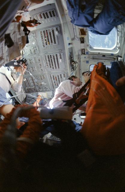 NASA image: STS-33 crewmembers on OV-103's aft flight deck photograph Earth observations