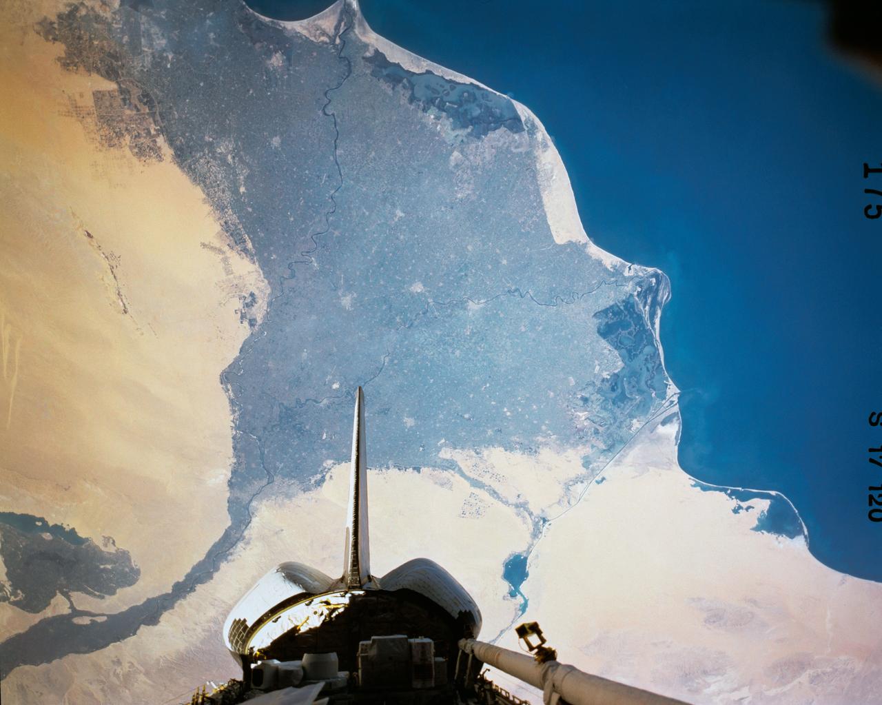 The Nile River Delta of Egypt (30.0N, 31.0E) irrigated by the Nile River and its many distributaries, is some of the richest farm land in the world and home to some 45 million people, over half of Egypt's population. The capital city of Cairo is at the apex of the delta. Just across the river from Cairo can be seen the ancient three big pyramids and sphinx at Giza and the Suez Canal is just to the right of the delta.